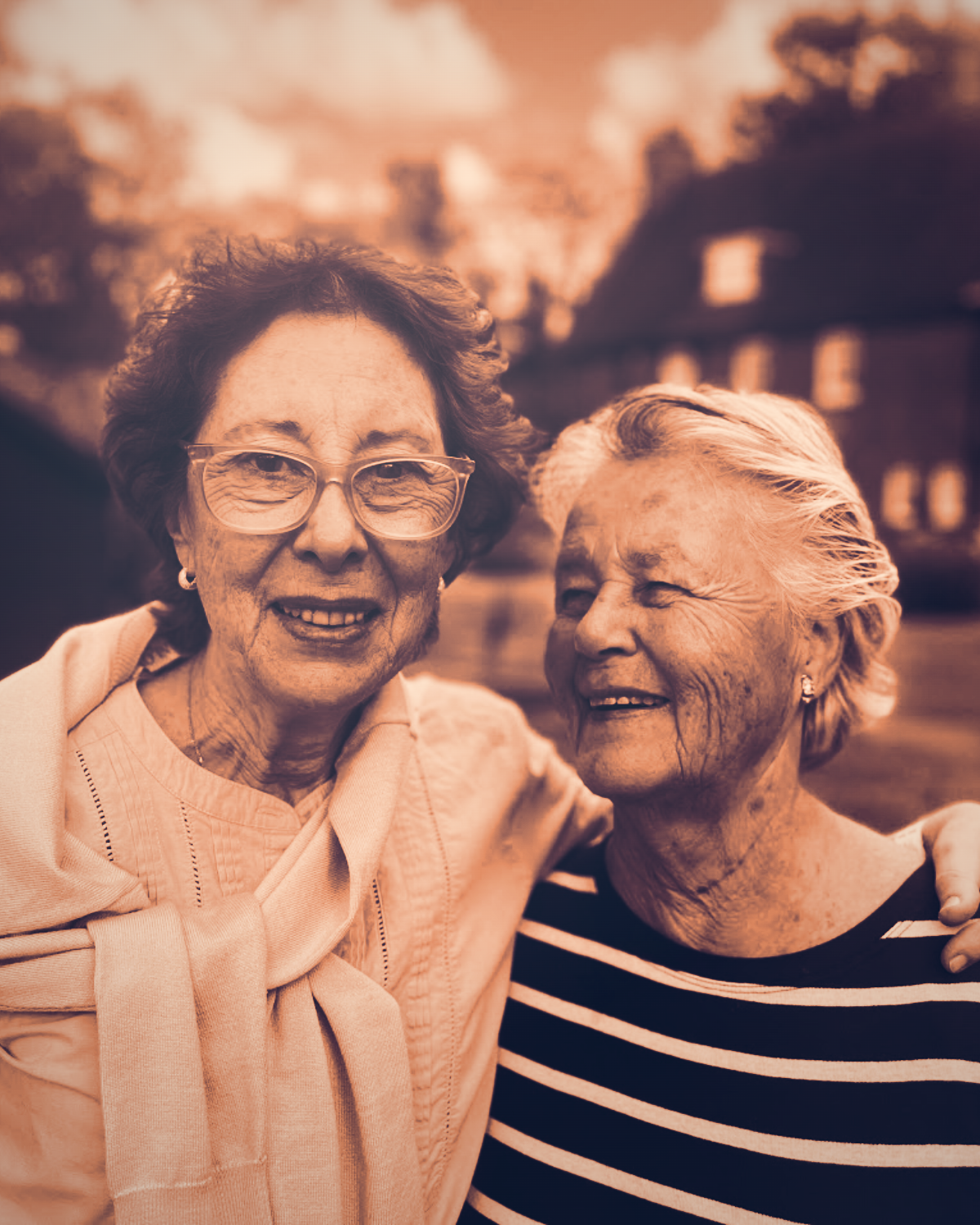 Two people in a garden, one with dementia and one their family caregiver.